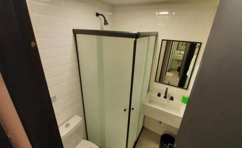 a bathroom with a shower and a toilet and a mirror at Hostel More SP in Sao Paulo