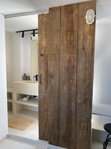 a sliding barn door in a room with a bedroom at Casa Limon in Pinos del Valle