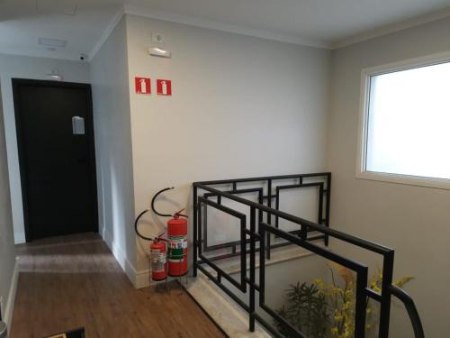 a stairway with a black railing next to a door at Hostel More SP in Sao Paulo