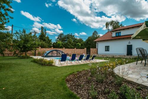 a yard with chairs and a swimming pool at Pod humnama in Krumvíř