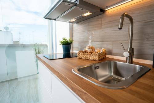 a kitchen with a stainless steel sink in a kitchen at Vico Blu in Polignano a Mare