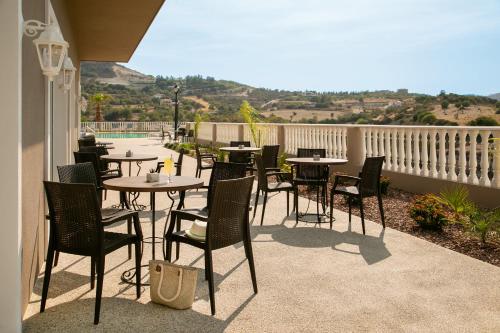 a patio with tables and chairs on a balcony at Archontiko Kiverniti in Pano Lefkara