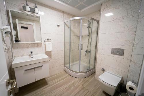 a bathroom with a shower and a sink and a toilet at Tepehan by Özkul in Izmir