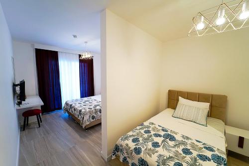 a bedroom with a bed and a desk in a room at Tepehan by Özkul in Izmir