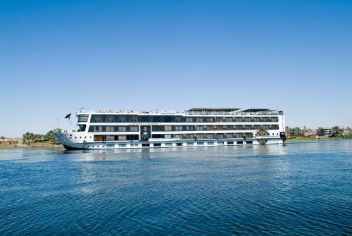 a large cruise ship sitting on the water at SUNRISE Semiramis II Cruise in Luxor