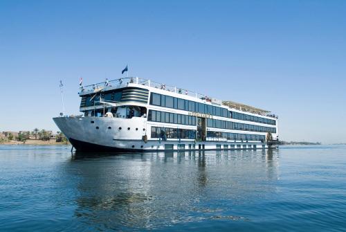 a large cruise ship sitting in the water at SUNRISE Semiramis II Cruise in Luxor