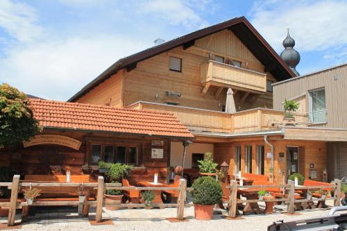 a building with tables and benches in front of it at Hotel-Restaurant Gasthaus Bonimeier in Niedergottsau