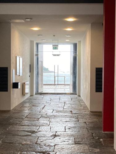 a hallway with a stone floor with a large window at Luxurious "THE BRUCE" - - Offering EITHER a LARGE FAMILY APARTMENT and OR a DELUXE STUDIO ROOM That CONNECT IN PRIVATE LOBBY - BOOK BOTH IF REQUIRED - So Beautifully Refurbished - - with FREE Onsite PARKING in Plymouth