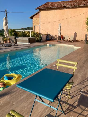 a blue ping pong table next to a swimming pool at La casa di Chiara in Diano dʼAlba