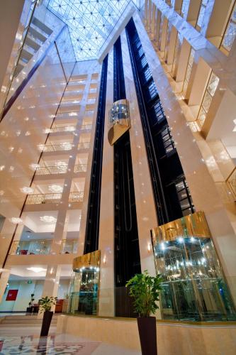 a large building with a escalator in a mall at Ramada Plaza by Wyndham Gence in Ganja