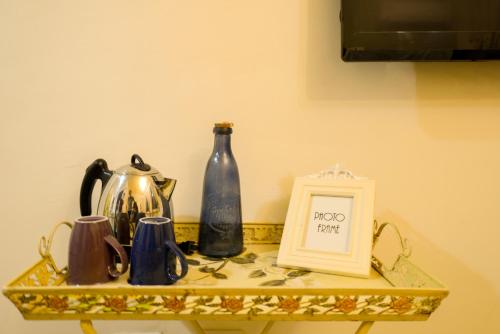 a shelf with two bottles and a framed picture on it at 高雄市包棟民宿-高雄寵物友善民宿-高雄阿爾兔兔民宿-Rabbit house in Kaohsiung