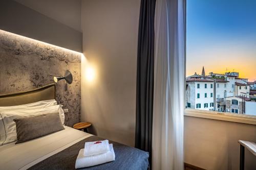 Postel nebo postele na pokoji v ubytování Palazzo dei Conti Residenza d'Epoca