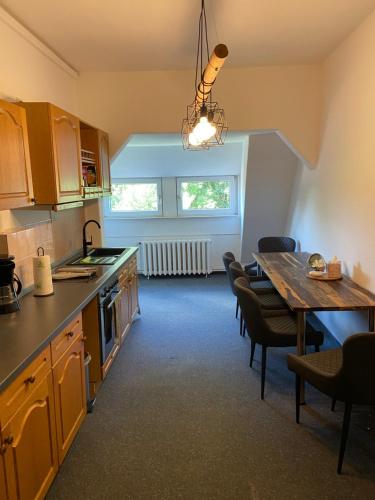 a kitchen with a table and a dining room at Villa Schomberg in Spremberg