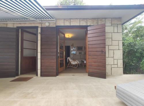 a house with doors open to a patio at Holiday Home Anja in Supetar