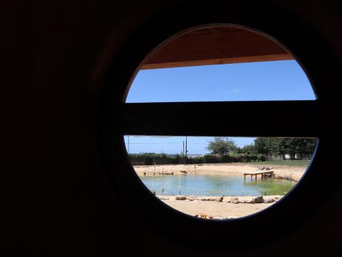 a view of a beach through a window at Associação Quinta das Relvas in Branca