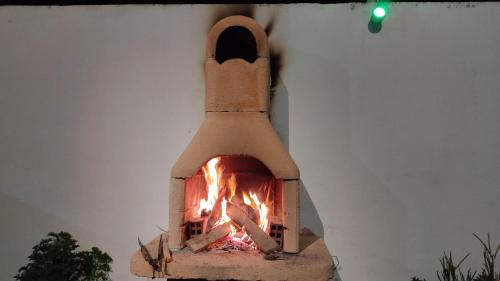 a pizza oven with a fire in it at Dar Lebharr Kélibia in Kelibia