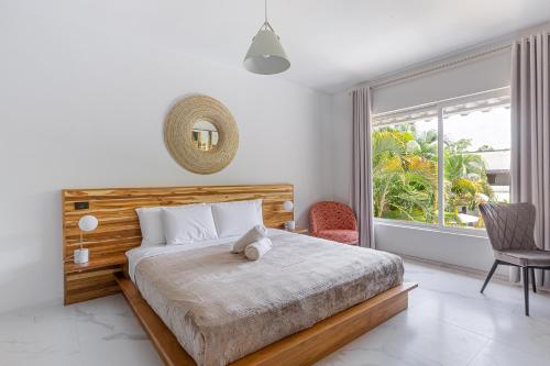 a bedroom with a bed and a large window at Peace Villa Santa Teresa - Walking distance to the beach in Santa Teresa Beach