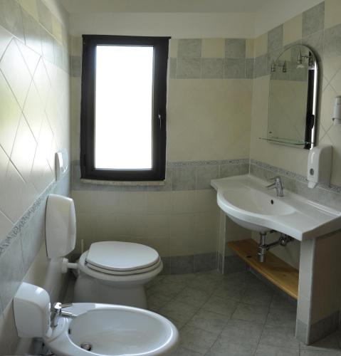 a bathroom with a toilet and a sink at HOTEL IL CORALLO in Fiuggi