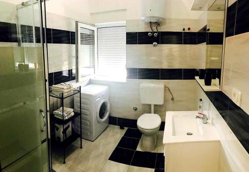a bathroom with a toilet and a sink and a shower at Apartmani Maki in Omiš