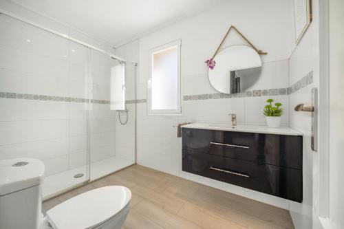 a bathroom with a toilet sink and a mirror at Villa Sol Felostal in Palma de Mallorca