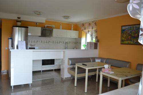 a living room with a table and a kitchen at Guest House at Lesya Ukrainka in Truskavets