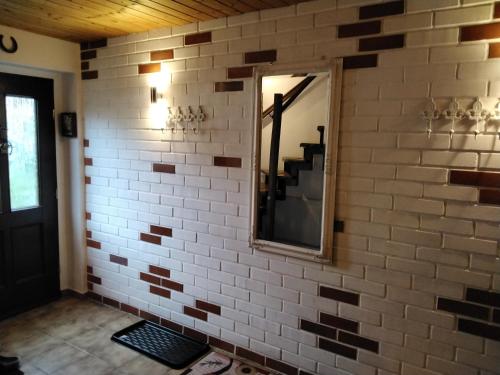 a brick wall with a mirror and a staircase at Pusteblume in Groitzsch