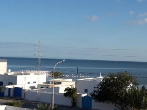 a view of the beach from a building with a street light at Appart Gyptis Résidence Chahrazad in Sfax