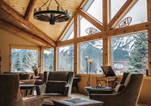 a living room with a large room with windows at Canmore Rocky Mountain Inn in Canmore