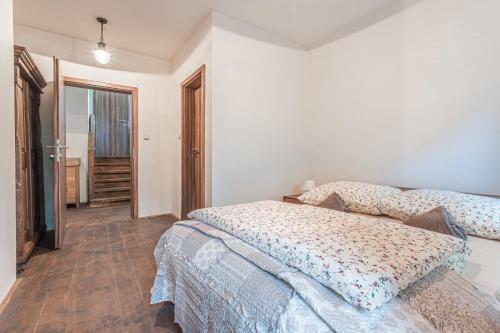 a bedroom with two beds and a hallway at Buškovský mlýn 1580 in Dolní Bousov
