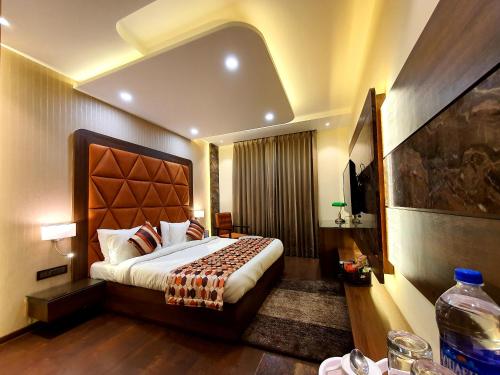 a bedroom with a large bed in a room at Hotel Makhan Residency in Amritsar