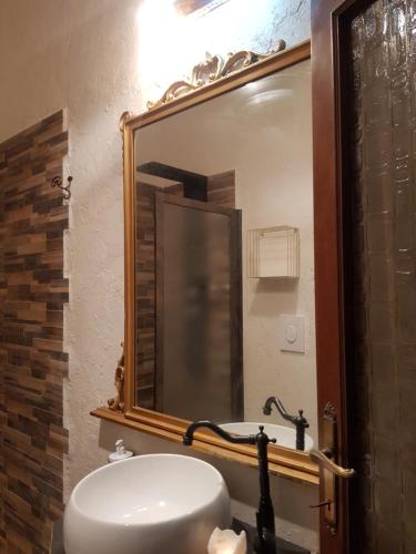 a bathroom with a sink and a large mirror at Dimora in San Quirico d'Orcia in San Quirico dʼOrcia