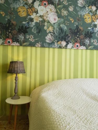 a bedroom with a bed and a table with a lamp at Dimora in San Quirico d'Orcia in San Quirico dʼOrcia