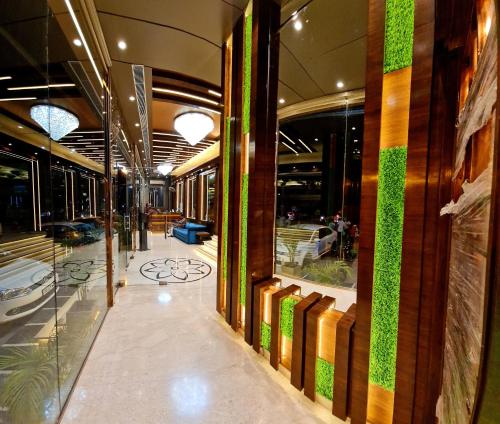a hallway of a building with a green wall at Hotel Makhan Residency in Amritsar