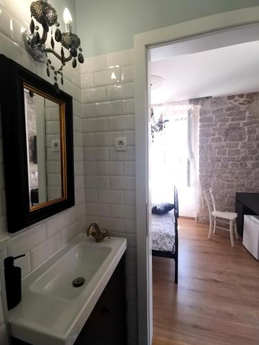 a bathroom with a sink and a mirror at L&L Rooms Royal in Šibenik