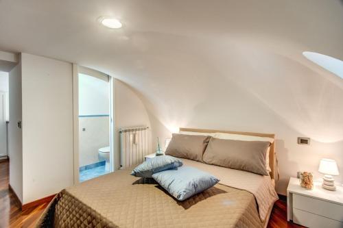 a bedroom with a large bed with a large window at House Archimede - eyes on the sea in Massa Lubrense