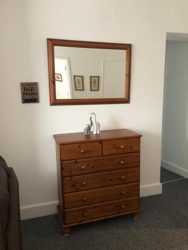 a dresser with a mirror on top of it at The Borough apartment in Kent