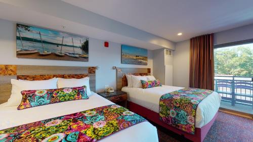 a hotel room with two beds and a window at Surfside On The Lake in Lake George