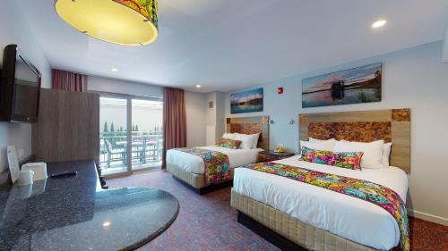 a hotel room with two beds and a balcony at Surfside On The Lake in Lake George