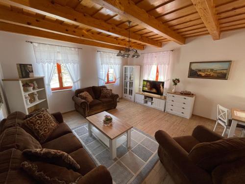 a living room with two couches and a coffee table at Rózsa Apartman Aggtelek in Aggtelek