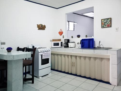 una cucina con lavello e fornello forno superiore di Entire Comfy apartment for you, 5 min SJO Airport a Alajuela