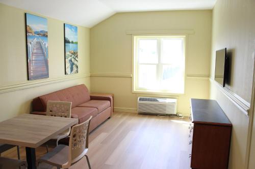 a living room with a couch and a table at Surfside On The Lake in Lake George