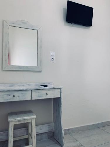 a dressing table with a mirror and a stool at Princess Sissy in Ios Chora