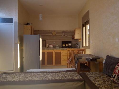 a living room with a kitchen with a refrigerator at amal's apart&studio in Agadir