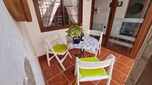 a table and chairs on a porch with a potted plant at Casa Mamatita in Agüimes