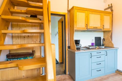 a kitchen with a bunk bed and a kitchen with a counter at Atelier Recreation Village in Râşnov