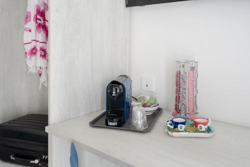 a kitchen counter with a coffee maker on it at Poseidonia Rooms in Procida