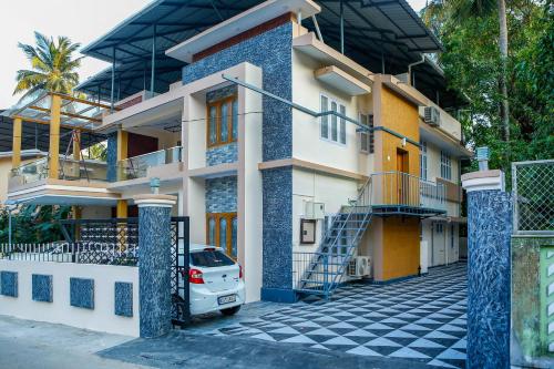 a house with a car parked in front of it at Belljem Homes -your own private resort -4 BHK FF in Trichūr