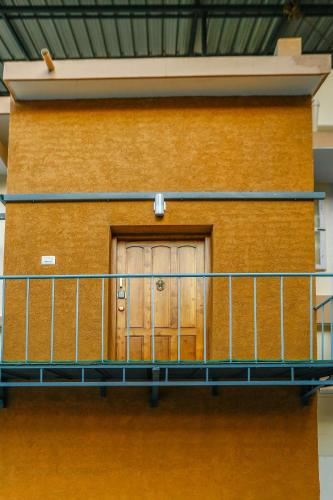 a balcony with a door on the side of a building at Belljem Homes -your own private resort -4 BHK FF in Trichūr