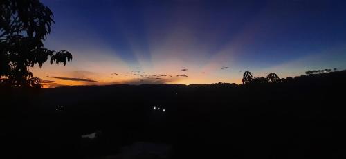 a sunset with birds flying in the sky at Mountain View Anapoima in Anapoima