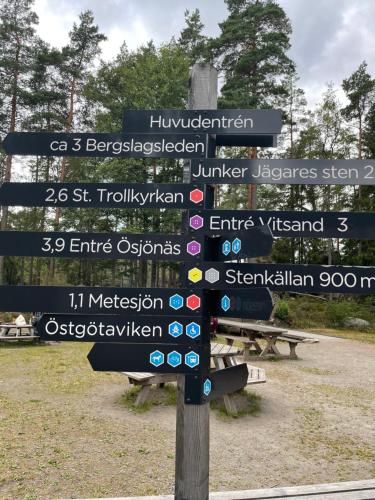a street sign with many different signs on it at Three Rooms stuga i stugby near National Park in Undenäs